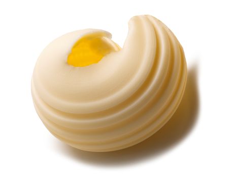 Butter curl or roll. Clipping paths, shadow separated