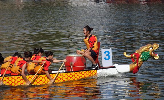 KAOHSIUNG, TAIWAN - JUNE 11: An unidentified team competes in the 2013 Dragon Boat Races on the Love River on June 11, 2013 in Kaohsiung