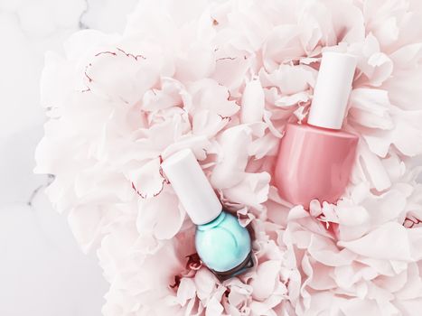 Nail polish bottles on floral background, french manicure and cosmetic branding design