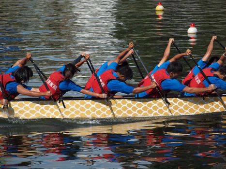 KAOHSIUNG, TAIWAN - JUNE 11: A team from Shu-Te College competes in the 2013 Dragon Boat Races on the Love River on June 11, 2013 in Kaohsiung