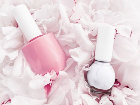 Nail polish bottles on floral background, french manicure and cosmetic branding design