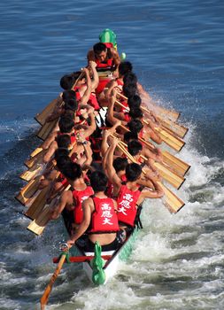 KAOHSIUNG, TAIWAN - JUNE 11: The Science University  team competes in the 2013 Dragon Boat Races on the Love River on June 11, 2013 in Kaohsiung
