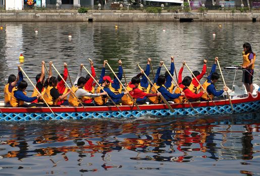 KAOHSIUNG, TAIWAN - JUNE 7:  An unidentified student team trains for the upcoming 2013 Dragon Boat Festival on the Love River on June 7, 2013 in Kaohsiung .