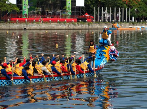 KAOHSIUNG, TAIWAN - JUNE 7:  An unidentified student team trains for the upcoming 2013 Dragon Boat Festival on the Love River on June 7, 2013 in Kaohsiung .