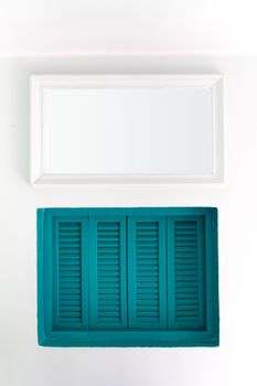 Blue wooden windows that are sealed on white walls