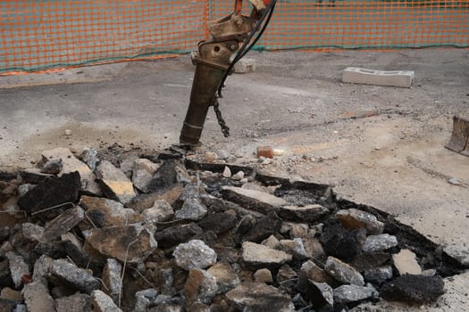 Road construction site. Demolition of the asphalt of a road with a jackhammer.