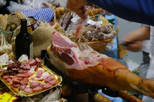 A sliced cured meat Prosciutto di Parma and cured meats. Parma ham is an Italian culinary specialty.