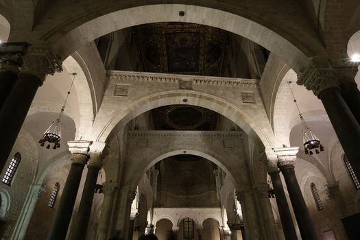 Bari, Puglia, Italy. About 11/2019. Interior of the Basilica of San Nicola in Bari. Arches, columns, capitals and limestone walls.
