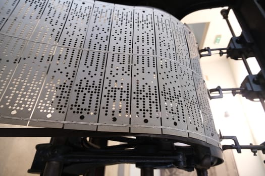 Perforated cards for programming an ancient machine for the production of yarns and fabrics.