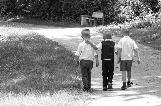 Group Of Children Running Along Path Towards Camera In Park