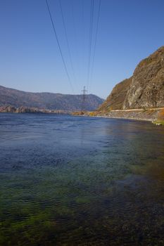 The mountains and the shore near the large mountain river.