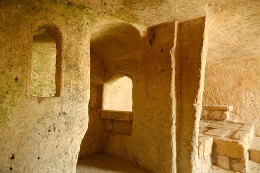 Sassi of Matera with arched ceilings and vaults. Ancient underground house dug out of the tufa rock.