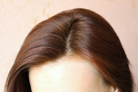 Women's hair is a top view close-up.