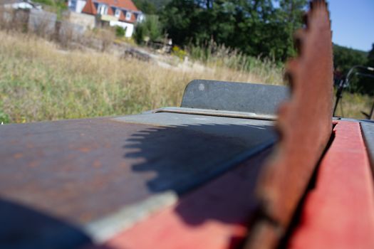 Round saw with teeth in the machine and its shadow.