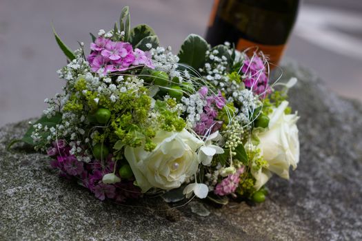 Wedding bouquet and bottle of wine.