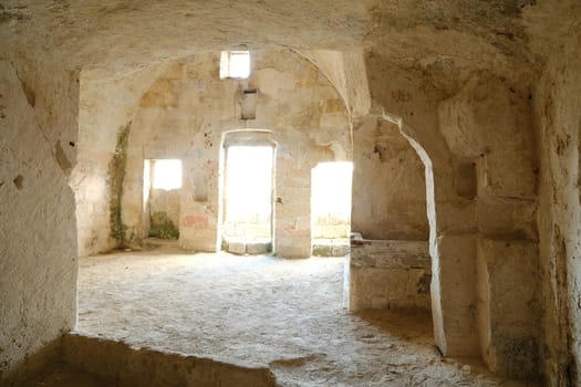 Sassi of Matera with arched ceilings and vaults. Doors and windows in an ancient underground house dug out of the tufa rock.