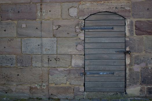 Wooden door in an old wall