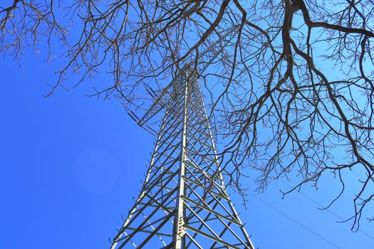 Close up view on a big power pylon transporting electricity in a countryside area in Europe