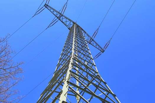 Close up view on a big power pylon transporting electricity in a countryside area in Europe