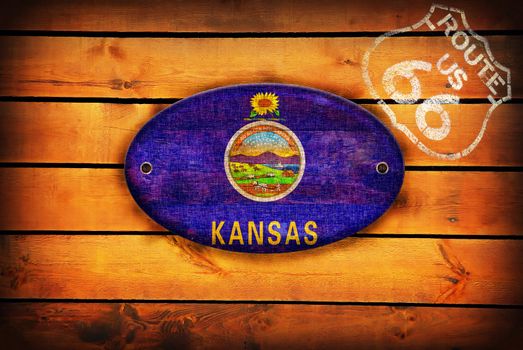 Brown wooden planks with the Kansas flag and shield of Route 66.