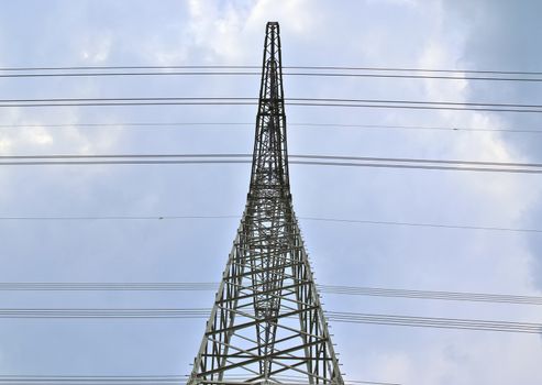 Close up view on a big power pylon transporting electricity in a countryside area in Europe