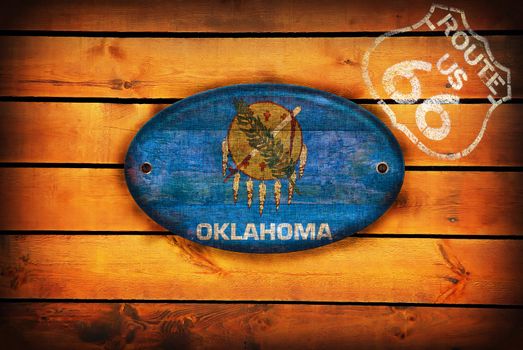 Brown wooden planks with the Oklahoma flag and shield of Route 66.