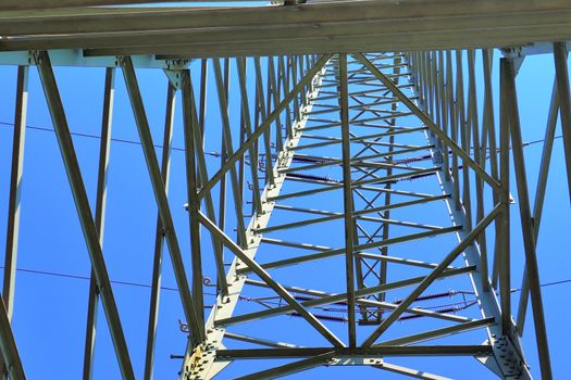 Close up view on a big power pylon transporting electricity in a countryside area in Europe