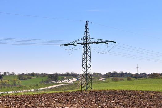 Close up view on a big power pylon transporting electricity in a countryside area in Europe