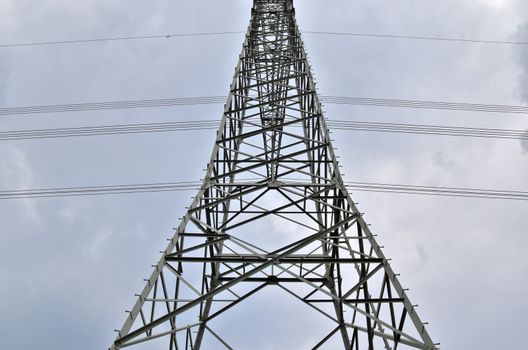 Close up view on a big power pylon transporting electricity in a countryside area in Europe