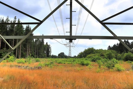 Close up view on a big power pylon transporting electricity in a countryside area in Europe