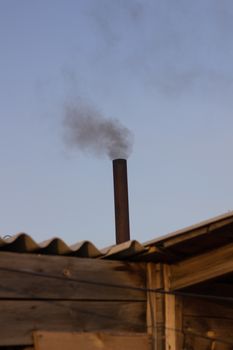 kindling bath in full swing, belching black smoke from the chimney