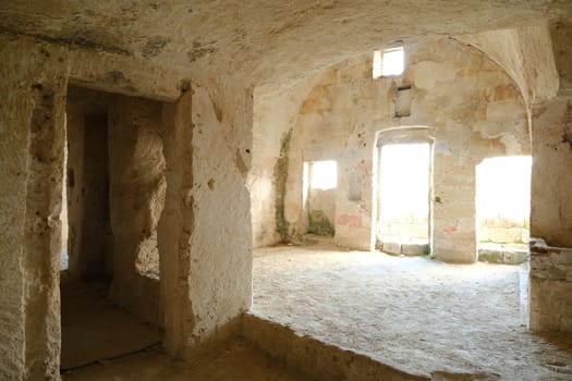 Sassi of Matera with arched ceilings and vaults. Doors and windows in an ancient underground house dug out of the tufa rock.