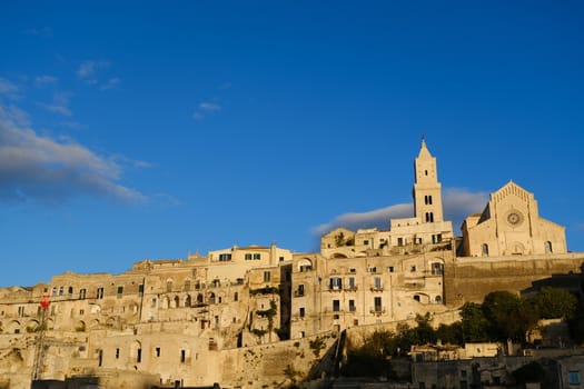 Houses, church and bell tower in the city of Matera in Italy. The tuff blocks are the material used for the construction of the houses.
