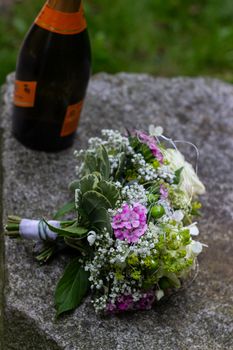 Wedding bouquet and bottle of wine.