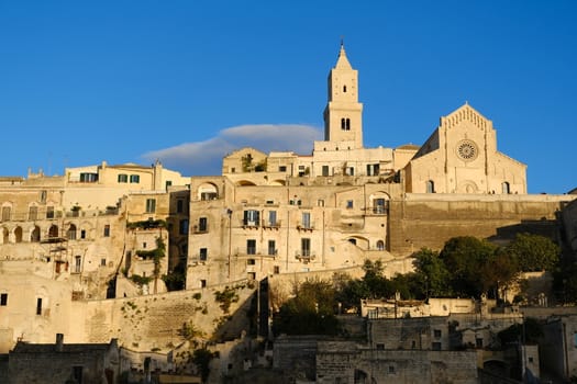 Houses, church and bell tower in the city of Matera in Italy. The tuff blocks are the material used for the construction of the houses.