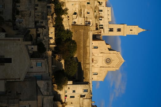 Houses, church and bell tower in the city of Matera in Italy. The tuff blocks are the material used for the construction of the houses.