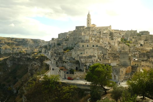 Matera, Italy. About 11/2019. View of the city of Matera in Italy. Church with bell tower and houses built in beige tuff stone.