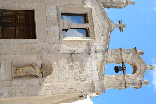Matera, Italy. About 11/2019. Church of San Biagio in Matera located in the Foggiali area. The construction is made of blocks of tufa stone of beige color. Facade with two small bells.