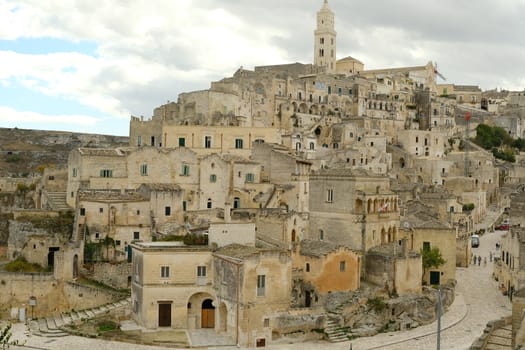Matera, Basilicata, Italy. About 11/2019. View of the city of Matera in Italy. Church with bell tower and houses built in beige tuff stone.
