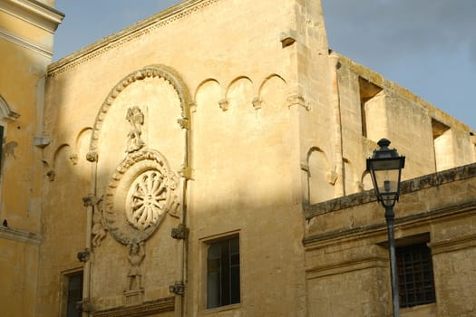 Facade of the Romanesque church of San Domenico in Matera. Built in tufa stone of beige color.