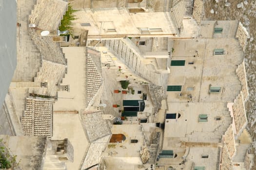 Matera, Basilicata, Italy. About 11/2019. Houses, roads and alleys in the Sassi of Matera. Typical dwellings carved into the rock and with facades of beige tuff blocks.