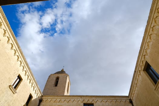 Matera, Italy. About 11/2019. Convent of Sant'Agostino in Matera. Beige stone facade with blue sky and clouds.
