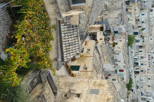 Matera, Basilicata, Italy. About 11/2019.  Houses, roads and alleys in the Sassi of Matera. Arbor with vine plants in autumn.