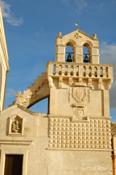 Materdomini Church in Piazza Vittorio Veneto of Matera. Built flat bell tower with balustrade in beige tuff.