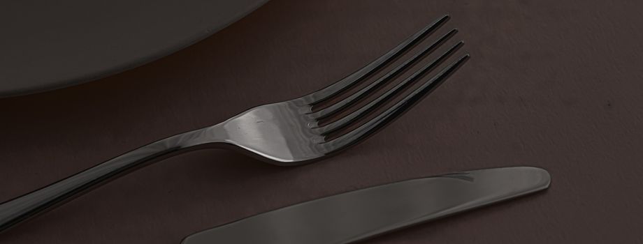 Empty plate and cutlery as mockup set on dark brown background, top tableware for chef table decor and menu branding design