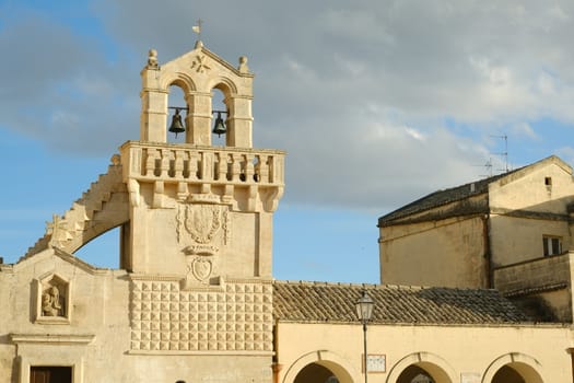 Materdomini Church in Piazza Vittorio Veneto of Matera. Built flat bell tower with balustrade in beige tuff.