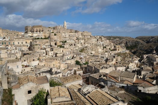 Panorama of houses and of the Sassi of Matera with roofs and streets. Blue sky with 