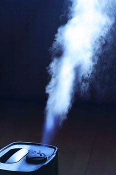 Closeup of home modern humidifier with white water steam