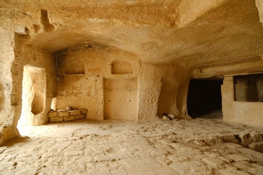 Matera, Basilicata, Italy. About 11/2019. Sassi of Matera with arched ceilings and vaults. Doors and windows in an ancient underground house dug out of the tufa rock.