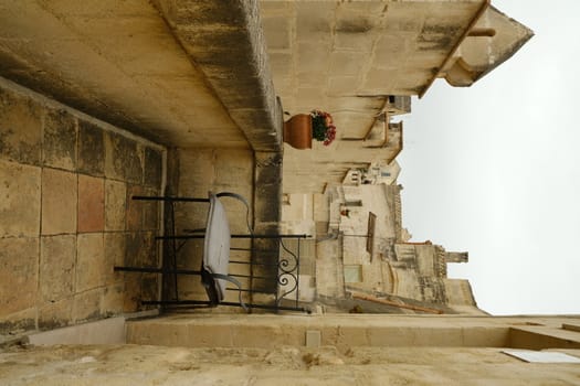 Balcony with iron chairs in a house in the city of Matera.